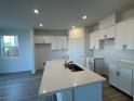 Modern kitchen featuring white cabinets, a stylish island, and stainless steel appliances at 5163 Capucina St # Lot 3, Las Vegas, NV 89122