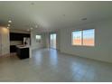Bright living room featuring tile floors, recessed lighting, and large windows overlooking the backyard at 5175 Capucina St # Lot 5, Las Vegas, NV 89122