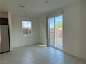 Open-concept living area with tile floors, glass sliding doors, and backyard access at 5175 Capucina St # Lot 5, Las Vegas, NV 89122