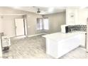 Bright living space with modern floors, large windows, and open access to the kitchen at 579 Grimsby Ave, Henderson, NV 89014