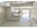 Bright, open-concept living space featuring modern flooring and an adjacent kitchen area at 579 Grimsby Ave, Henderson, NV 89014