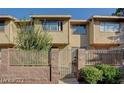 Charming townhome featuring a private fenced yard, mature landscaping, and a well-maintained facade at 6463 Big Pine Way, Las Vegas, NV 89108