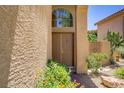 Inviting front entrance with a double door, textured stucco, and vibrant landscaping at 7813 Paper Flower Ct, Las Vegas, NV 89128