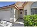 Close-up of front entrance showcasing well-kept landscaping, exterior paint, and a secure, metal screen door at 8109 Sunset Mill Dr, Las Vegas, NV 89128
