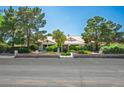Lovely single-story home with manicured landscaping, mature trees, and an inviting entrance at 8365 S Hauck St, Las Vegas, NV 89139