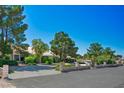 Beautiful single-story home featuring a long driveway and lush landscaping creating an inviting curb appeal at 8365 S Hauck St, Las Vegas, NV 89139