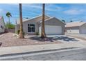 Single story home with a 2 car garage, xeriscaped front yard, and tile roof at 887 Cozy Valley St, Henderson, NV 89015