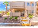 Inviting two-story condo featuring private balcony, desert landscaping, and convenient stair access at 904 Boulder Springs Dr # 102, Las Vegas, NV 89128