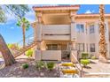 Charming two-story condo featuring private balcony, desert landscaping, and convenient stair access at 904 Boulder Springs Dr # 102, Las Vegas, NV 89128