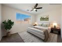 Bright bedroom with a large window, neutral colors, and comfortable furnishings at 909 Trinity Pond Cir, Henderson, NV 89002