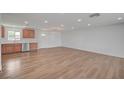 Open-concept living room with gorgeous wood floors and seamlessly connected to the kitchen at 929 Center St, Henderson, NV 89015