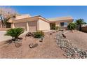 Inviting single-story home featuring a two-car garage and xeriscaped front yard at 945 Stetson Dr, Henderson, NV 89002