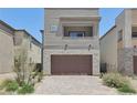Stylish two-story home boasts a stone-accented facade and a neatly paved driveway at 9714 Harper Edge St, Las Vegas, NV 89143