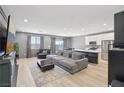 Spacious living room features a large sectional, modern fireplace, and stylish decor at 9714 Harper Edge St, Las Vegas, NV 89143