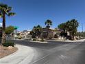 Gated community entrance featuring mature palm trees and manicured landscaping near the 'Monument' sign at 10645 Alpine Frost Ct, Las Vegas, NV 89129