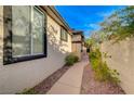 A secluded walkway with manicured landscaping, adding privacy to the home at 11441 Drappo Ave, Las Vegas, NV 89138