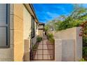 Private side yard showcasing a gated walkway and well maintained landscape at 11441 Drappo Ave, Las Vegas, NV 89138