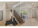 Elegant dining room with modern staircase, chandelier, and views of the front entrance at 11550 Lampeter Ct, Las Vegas, NV 89138