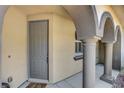 Covered entryway featuring arched columns and a gray front door at 1560 Plaza Centre Dr # 103, Las Vegas, NV 89135