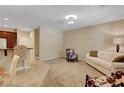 Open-concept living area with plush sofa and bar seating, great for entertaining at 1560 Plaza Centre Dr # 103, Las Vegas, NV 89135