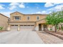 Charming two-story home featuring a three car garage, desert landscaping, and covered front entryway at 1808 Peyton Stewart Ct, North Las Vegas, NV 89086