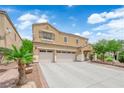 Charming two-story home featuring a three car garage, desert landscaping, and covered front entryway at 1808 Peyton Stewart Ct, North Las Vegas, NV 89086