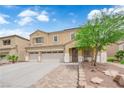 Charming two-story home featuring a three car garage, desert landscaping, and covered front entryway at 1808 Peyton Stewart Ct, North Las Vegas, NV 89086