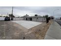 A view of the fenced backyard, with a concrete platform and updated windows at 2036 Canosa Ave, Las Vegas, NV 89104