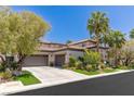 Attractive stucco home with a spacious three-car garage and well-maintained front yard at 2436 Grassy Spring Pl, Las Vegas, NV 89135