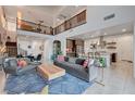 Spacious living room with high ceilings and an open floor plan, leading into the kitchen at 2669 Via Monet, Henderson, NV 89044