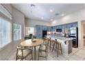 Bright kitchen featuring blue cabinets, stainless steel appliances, and marble countertops at 3050 Whispering Crest Dr, Henderson, NV 89052