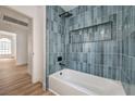 Stylish bathroom with tub, blue tiling, and modern black fixtures at 3104 Waterview Dr, Las Vegas, NV 89117