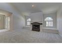 Spacious living room with a fireplace, large arched windows with bright neutral walls and carpet at 3145 E Flamingo Rd # 2080, Las Vegas, NV 89121