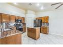 Well-lit kitchen features granite countertops, stainless steel appliances, and a functional center island for cooking at 3521 Amish Ave, North Las Vegas, NV 89031