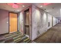 Hallway featuring exit signs and multiple doors that lead to units with safety and privacy at 353 E Bonneville Ave # 379, Las Vegas, NV 89101