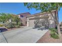 Exterior of the home showing the two-car garage, mature trees, and a well-maintained yard at 4020 Driscoll Mountain St, Las Vegas, NV 89129