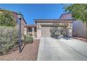 Charming home exterior features a two-car garage, low-maintenance landscaping, and a welcoming entrance at 4020 Driscoll Mountain St, Las Vegas, NV 89129