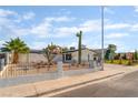 Inviting home showcasing desert landscaping, a white fence, and mature palm trees at 4301 Fortune Ave, Las Vegas, NV 89107