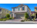 Attractive two-story home with a two-car garage, complemented by lush greenery and a brick driveway at 459 Astillero St, Las Vegas, NV 89138