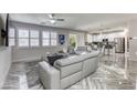 Spacious living room with marble floors, recessed lights, fan and modern gray furniture at 459 Astillero St, Las Vegas, NV 89138