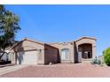 Inviting one-story home featuring desert landscaping, a two-car garage, and a warm, welcoming facade at 472 Tiger Lily Way, Henderson, NV 89015