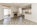 Bright living room with a fireplace and access to a patio, seamlessly connecting indoor and outdoor spaces at 472 Tiger Lily Way, Henderson, NV 89015