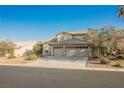 Two-story home featuring a two-car garage and desert landscaping at 5133 Burr Oak Dr, Las Vegas, NV 89130