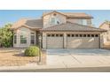 Two-story home featuring a two-car garage and desert landscaping at 5133 Burr Oak Dr, Las Vegas, NV 89130