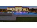 Stunning backyard pool area with modern lighting, an outdoor seating area and lush landscaping at 5400 Mello Ave, Las Vegas, NV 89131