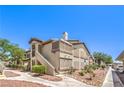 Beautiful exterior of a multi-Gathering home with well maintained landscaping, sidewalks, and covered parking at 5710 E Tropicana Ave # 1114, Las Vegas, NV 89122
