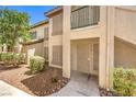 Exterior shot of multi-Gathering home entrance, featuring well-kept bushes and private balcony at 5710 E Tropicana Ave # 1114, Las Vegas, NV 89122