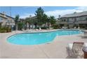 Large community pool with lounge chairs and umbrellas at 5710 E Tropicana Ave # 1114, Las Vegas, NV 89122