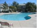 Community pool with lounge chairs at 5710 E Tropicana Ave # 1114, Las Vegas, NV 89122
