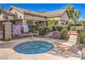 Relax in the community hot tub, surrounded by lush landscaping and a lounge chair at 5710 E Tropicana Ave # 1114, Las Vegas, NV 89122